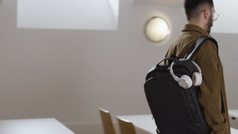 people with backpacks in a classroom