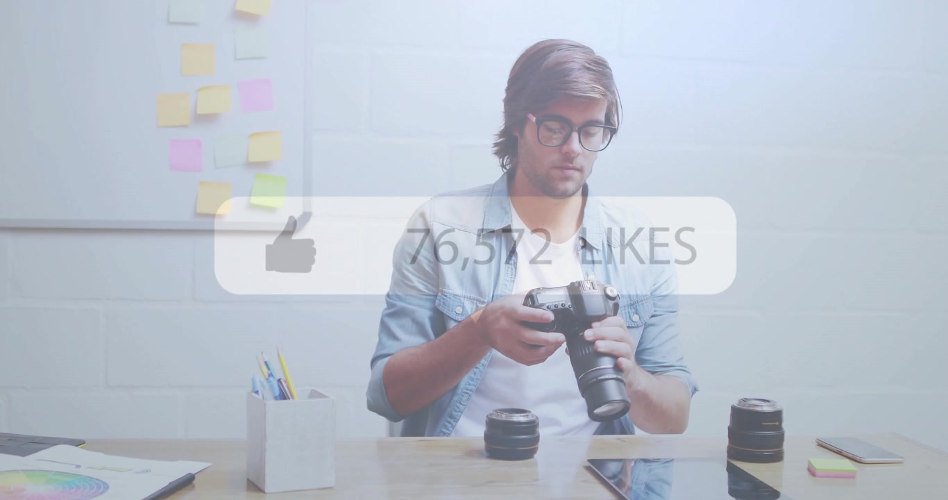 Content creator lifting camera and swapping lenses on desk, displaying animated like count rising