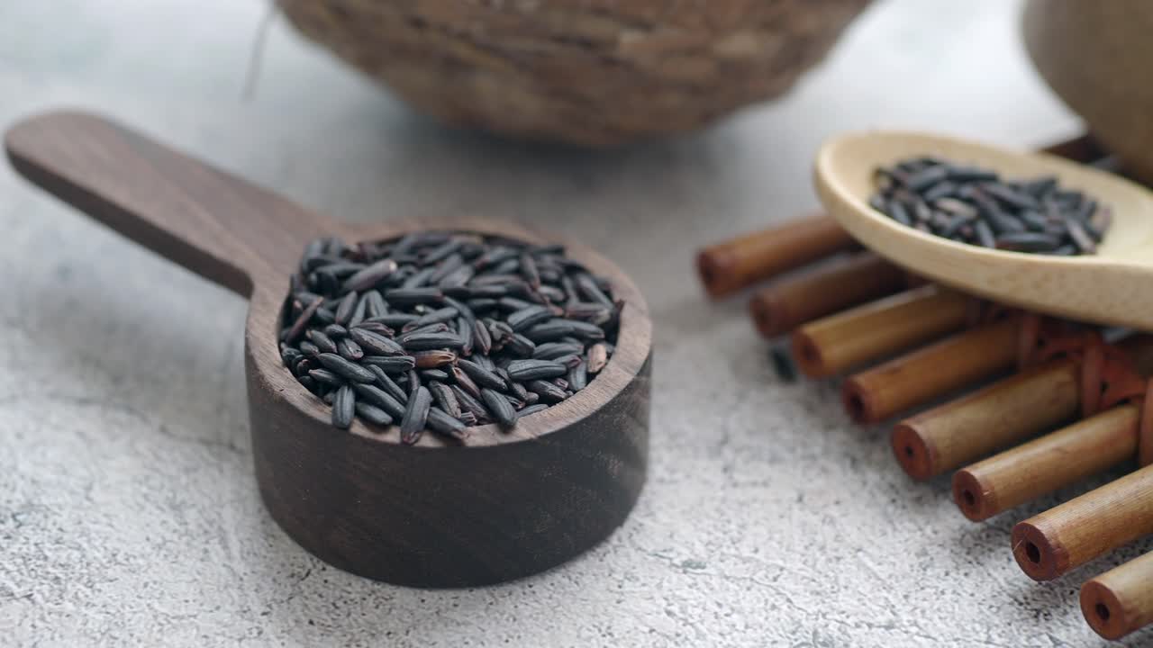 Closeup of Black Rice in a Wooden Spoon