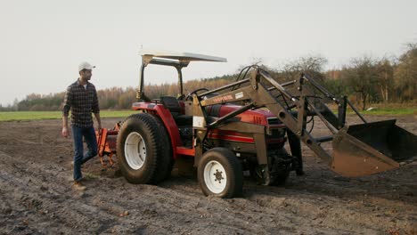 farmer working with tractor in field