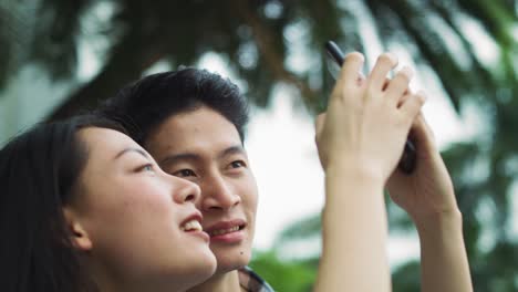 handheld view of vietnamese couple with mobile phone