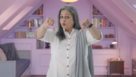 Disappointed-Indian-mother-showing-thumbs-down