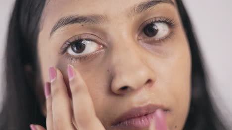 woman showing her under eye dark circle in white background