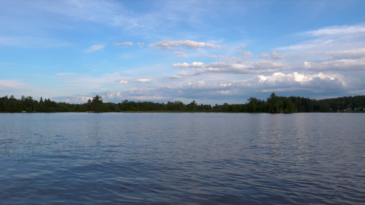 Calming Tranquil Lake Water Rippling Over Cotton Candy Skies - Water and Clouds in Ontario Canada