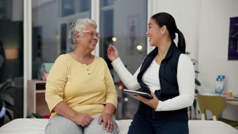 elderly woman and caregiver using tablet