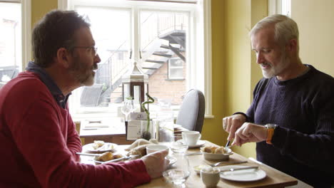 mature male gay couple eating in boutique hotel shot on r3d