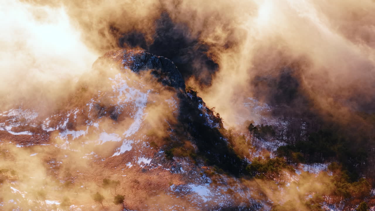Aerial fly dramatic golden sunrise landscape of Winter Above the Clouds mountain