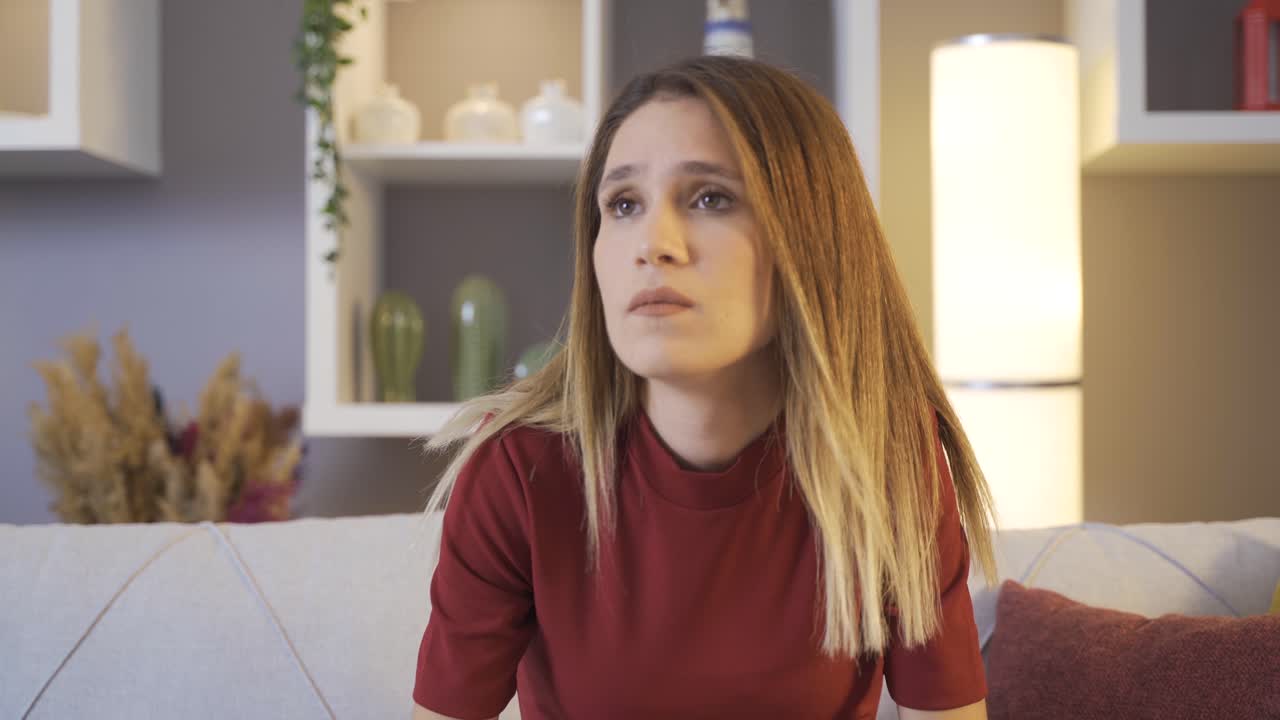 Worried woman looking around at home.