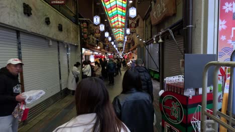 pedestrians navigating a busy indoor market