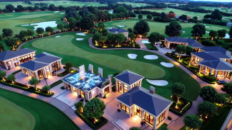 aerial view of luxury homes and golf course at dusk