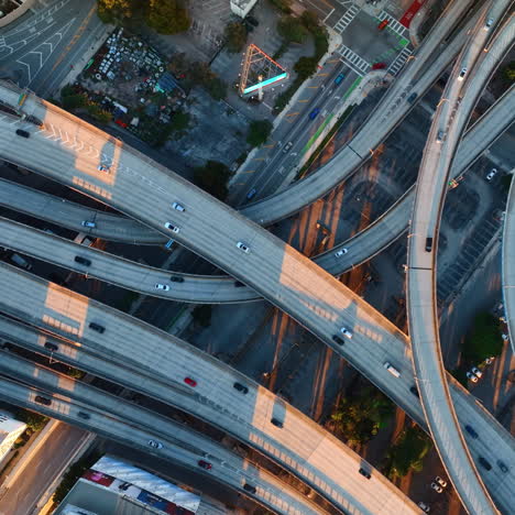 few speedways entwining in the downtown of big city. some cars run by the highways. top view.