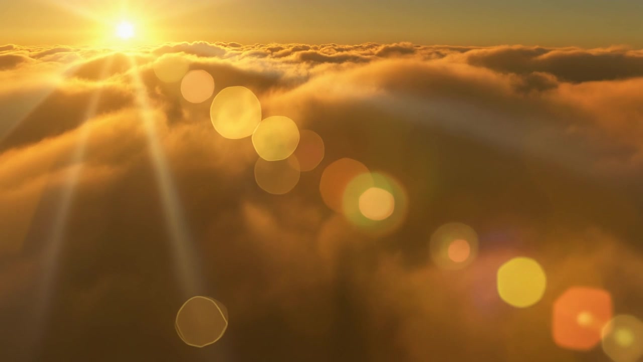 Aerial View of Golden Sunset Above Clouds