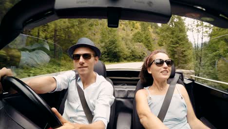 4k footage of a couple going in the convertible and singing