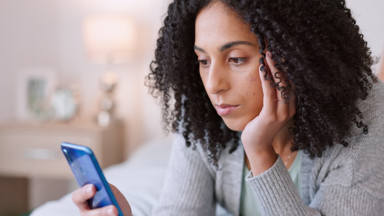 Lonely, bored and young woman on mobile phone