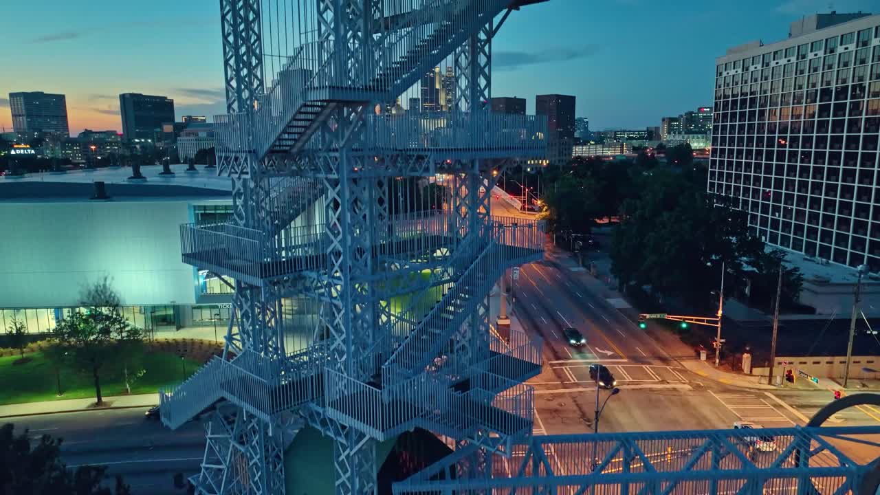 Rising Drone shot showing stairs of Olympic Torch Tower and Skyline of Atlanta City in background
