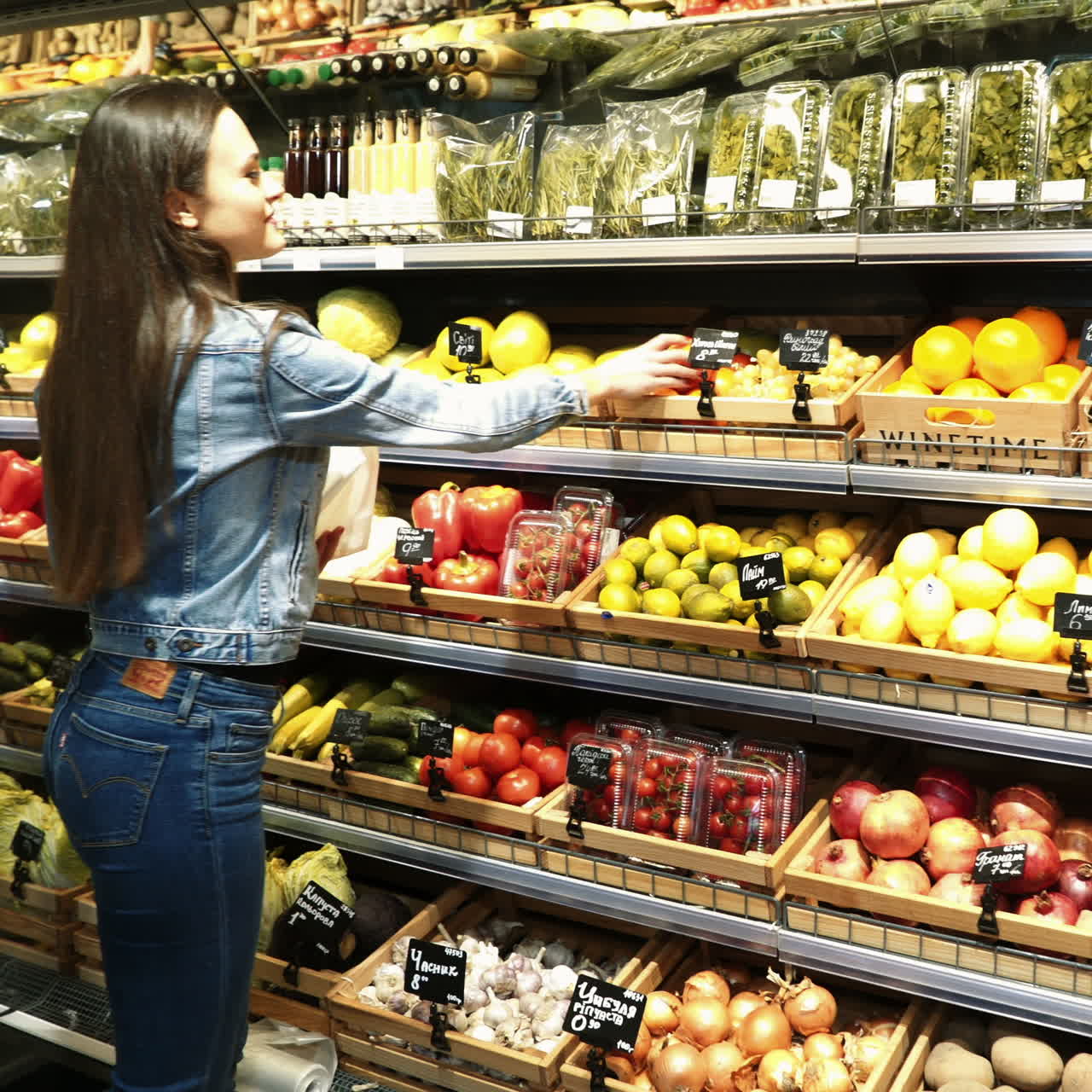 woman shopping for fruits and vegetables in produce department of a grocery store/supermarket Square video