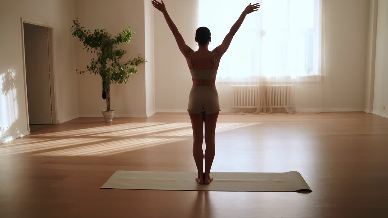 Woman Practicing Yoga or Stretching in a Bright Room