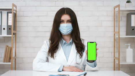 doctor presenting green screen phone