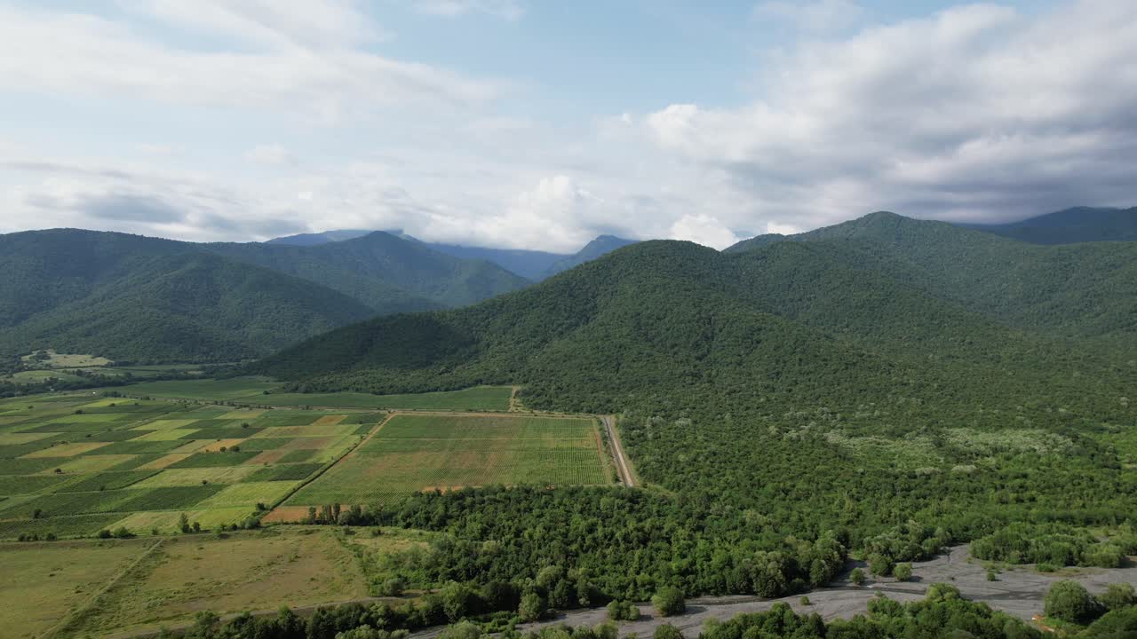 Aerial View of Serene Mountain Valley with Farmland