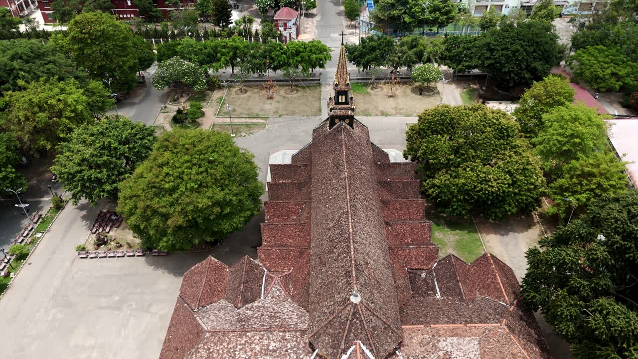 Drone footage above the black cathedral of Kon Tum, Vietnam. Unique structure in southeast asia made by precious wood in early XXth