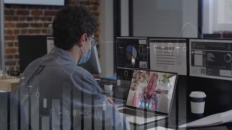 Data-processing-over-caucasian-man-wearing-a-face-mask-having-a-video-call-on-laptop-at-office