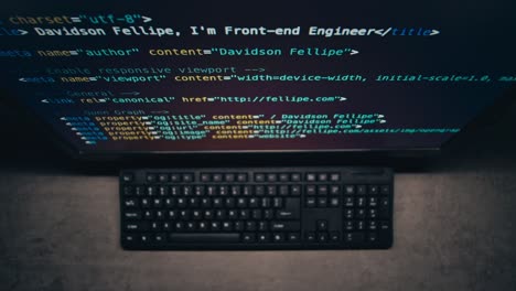 computer screen displaying code and keyboard