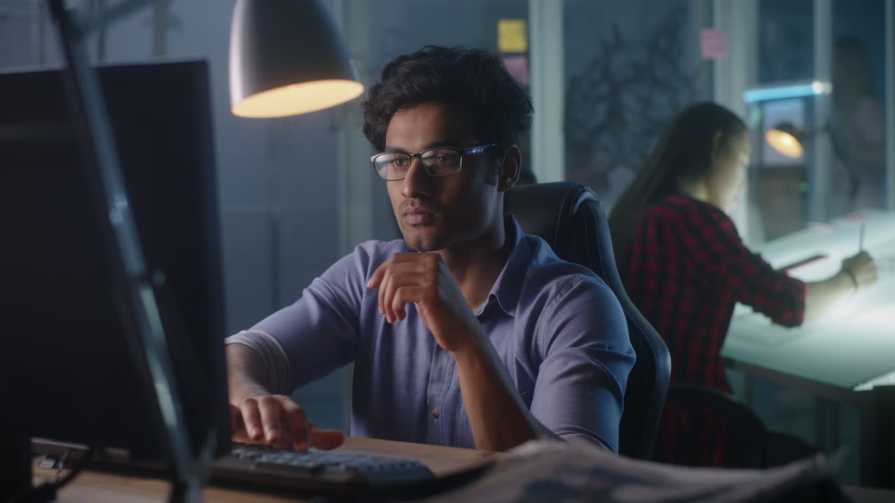 Focused Designer Working Late in Office