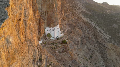 iconic cliffside monastery of panagia hozoviotissa bathed in morning light, amorgos island, greece