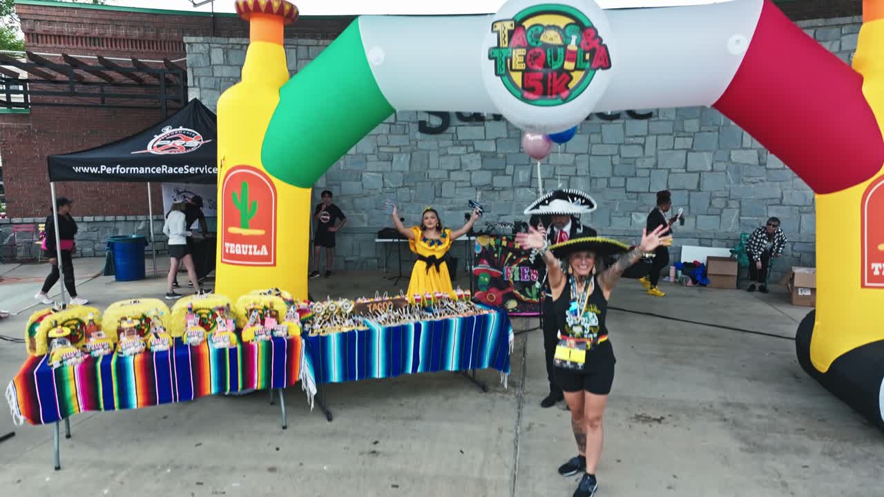 Event Hosts In Costumes At Tacos And Tequila 5K Race In Suwanee, Georgia, USA. wide shot
