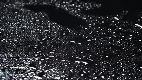 close-up video of water drops on black background