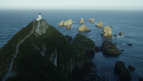 Landspace-shot-of-lighthouse-on-cliff-in-Milford-Sound