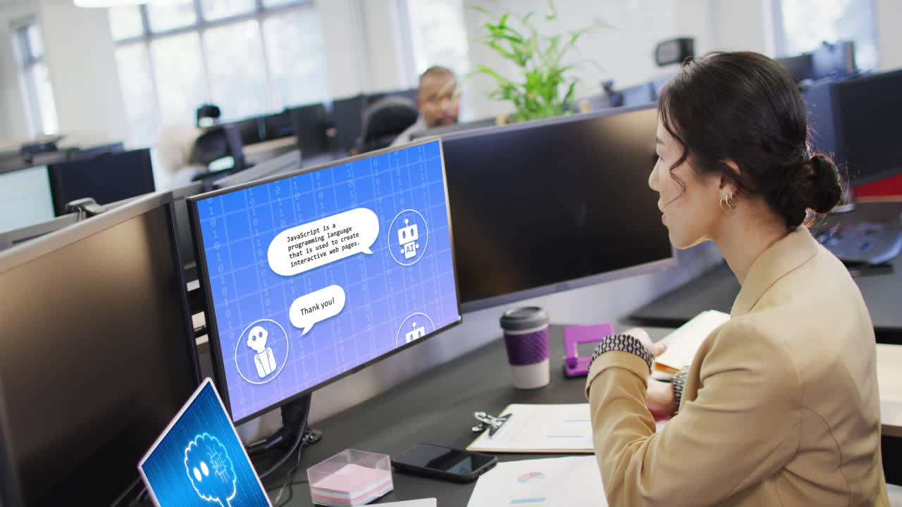 Asian businesswoman using computer with digital chat on screen in office