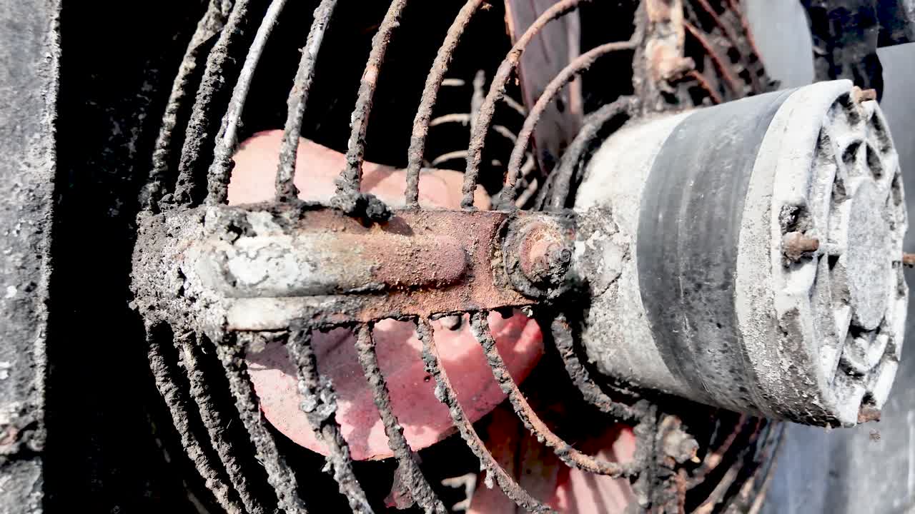 Close-up of a dirty rusty extraction fan in Thailand showcasing the wear and tear of an industrial ventilation system