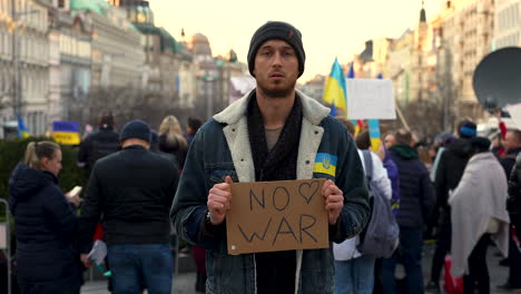 activist with protest sign against war in ukraine, prague, slow motion