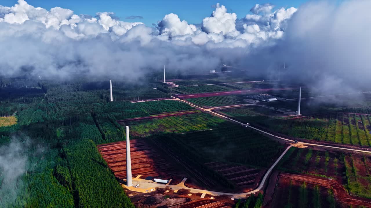 Renewable energy sector wind turbine farm under construction, aerial drone
