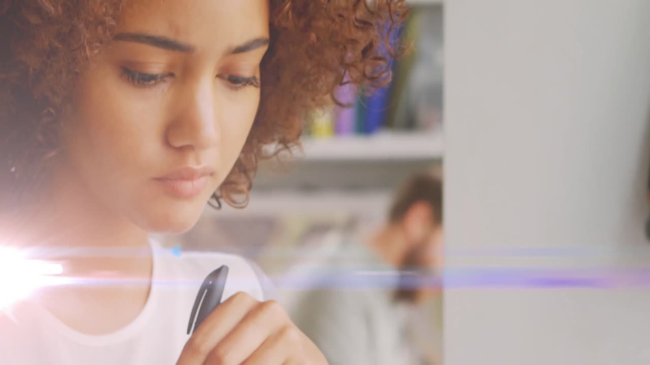 Animation of light spots over biracial woman with pen