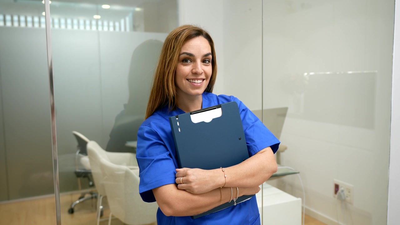 Profissional de Saúde Feminina Sorridente Segurando uma Prancheta em um Escritório Moderno