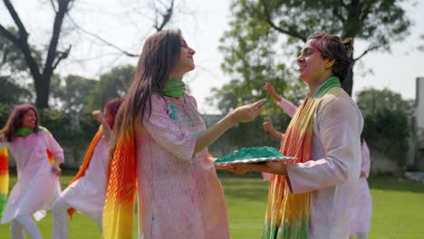 cute indian couple putting holi colors at each other faces