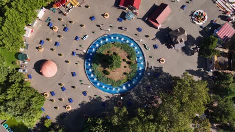 rotating aerial shot of an artesian fountain within oraselul copiilor amusement park, bucharest, romania