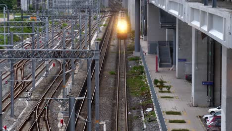 an inter-provincial train slows down as it approaches the train station before in comes to a full stop, in bang sue central station, bangkok thailand