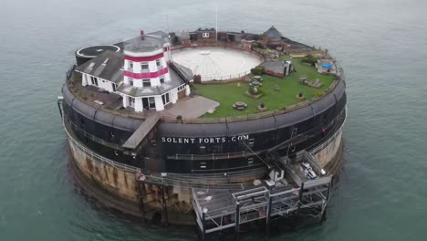 aerial drone flight around solent fort in the isle of wight showing the lighthouse and rooftop gardens