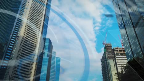 animación de múltiples círculos sobre vista de ángulo bajo de edificios modernos contra un cielo nublado