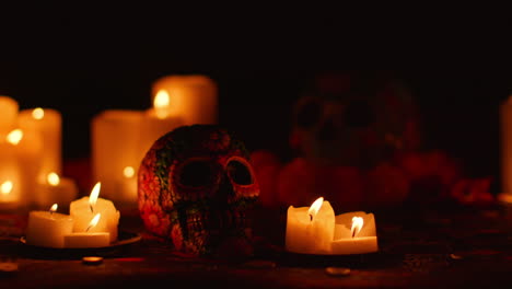 still life of decorated skull surrounded by candles celebrating mexican holiday of dia de muertos or day of the dead 1