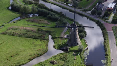 drone reveal lush rural dutch landscape from old rustic haastrecht windmill