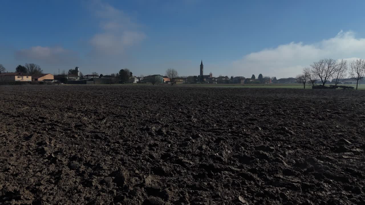 This low drone flyover captures freshly plowed farmland in Piacenza plain, with rich soil textures and open rows prepared for seeding—highlighting the quiet precision of rural agricultural cycles