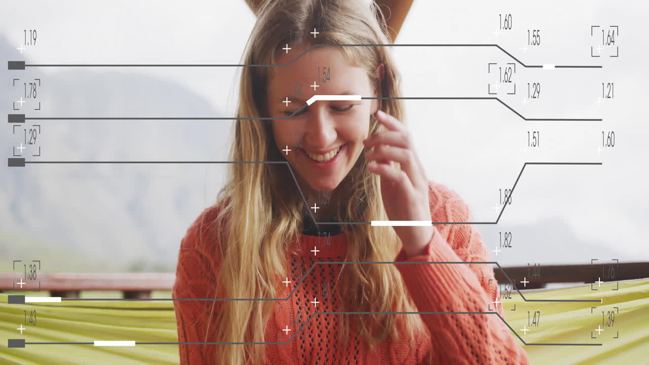 Woman brushing hair sitting on wooden porch overlooking mountains, showing AR data overlay