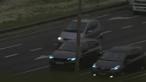 transport traffic on highway in the evening cars with lit headlights