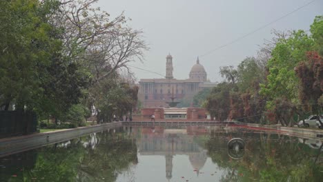 rajpath and central vista lawns renamed as kartavya path in poor air quality, low visibility, grey smog, foggy mist sky with reflection, new delhi, india