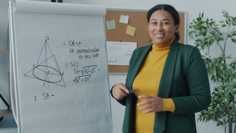 woman teacher explaining geometry on whiteboard