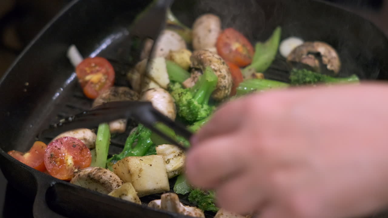 Frying assorted vegetables in a cast iron pan